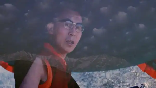 A close up of man wearing glasses, looking toward the camera