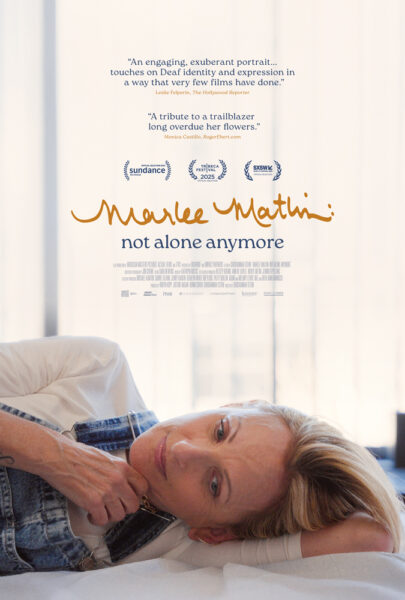A woman with short blonde hair lies on a bed, staring thoughtfully at the camera. Text above reads “Marlee Matlin: not alone anymore” with film festival accolades and reviews.