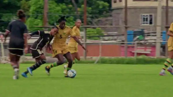 women soccer players rush to goal with soccer ball