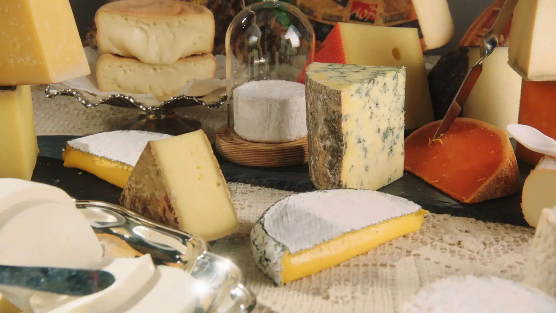 A close up of a table decorated with different types of cheeses.